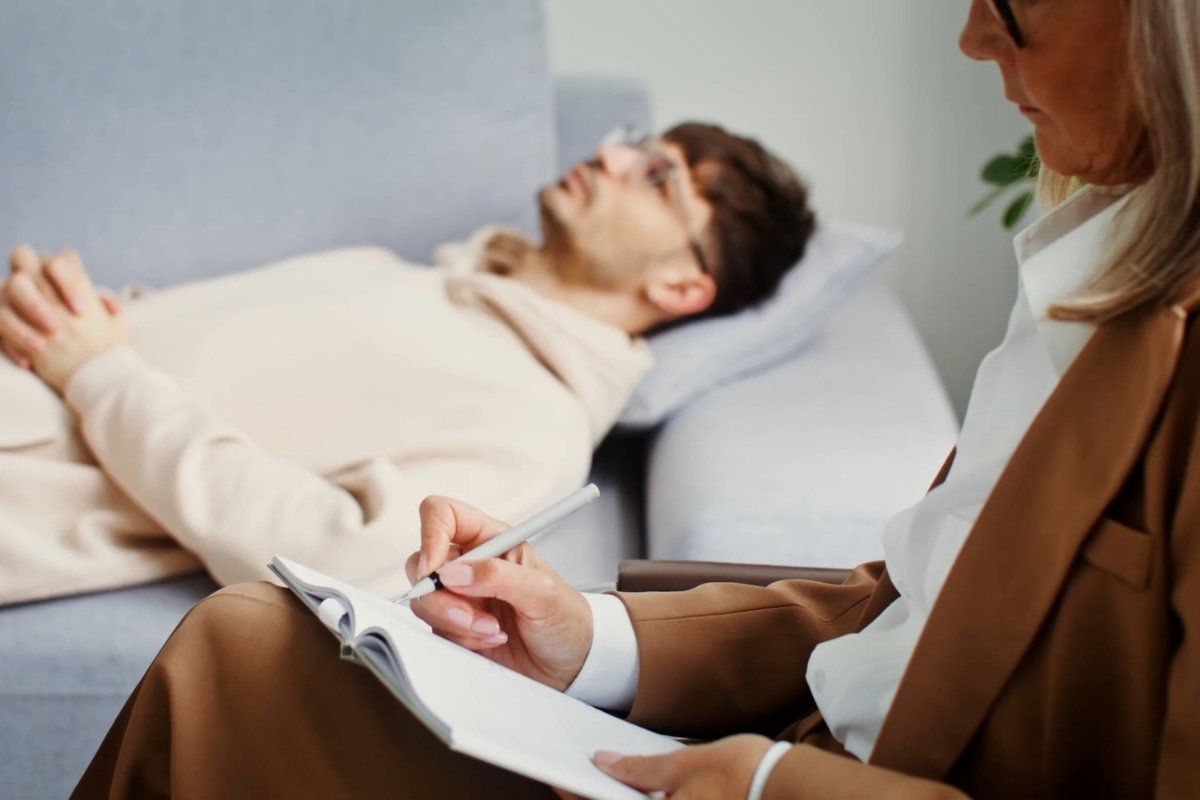 momak kod psihologa na seansi leži na krevetu i priča probleme